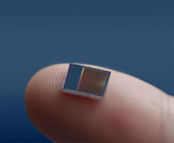 Close-up of Sony's IMX500 image sensor chip for vision AI placed on a fingertip